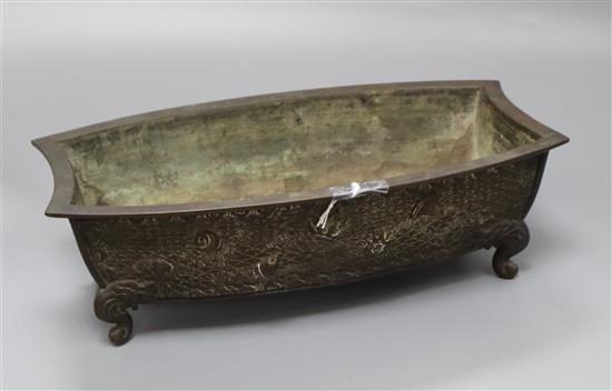 A Japanese Meiji bronze bonsai planter of shaped rectangular form cast with shells, on scrolled feet, signed to base, L 32cm